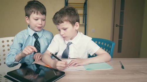 Two Young Boys Doing Schoolwork at Home