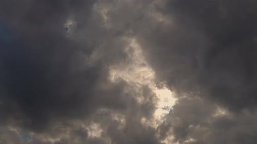 Storm Clouds Dissipate Revealing Sun and Blue Sky