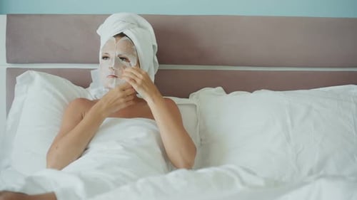 Woman with Paper Collagen Mask