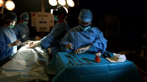 Medical Team Performing Surgery in Dark Operating Room