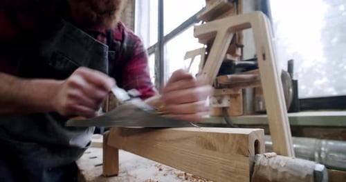 The Master Carpenter with a Planer at Work in the Workshop