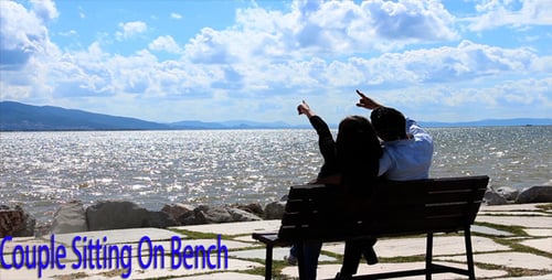 Couple Sitting on Bench at the Waterfront