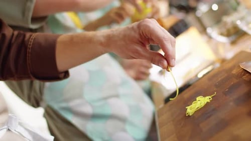 Adults Preparing Food Ingredients in a Sunny Kitchen