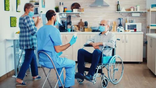 Healthcare Worker Explains Medication to Senior Man
