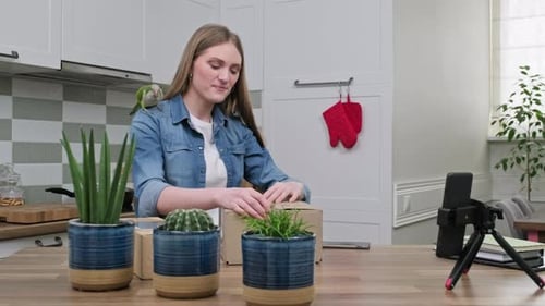 Woman Unpacking Box and Recording Video With Parrot