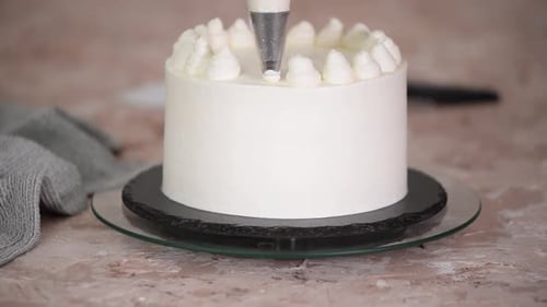 Decorating a Cake with Elegant Frosting Swirls