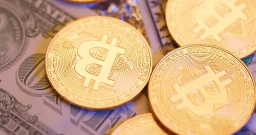 Gold Bitcoin Coins on US Dollar Bill