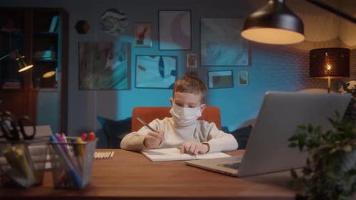 Students Return to School After COVID 19 Coronavirus Lockdown Kid Wearing a Mask Doing Homework on