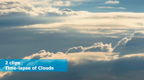Puffy White Clouds Drifting Across Blue Sky