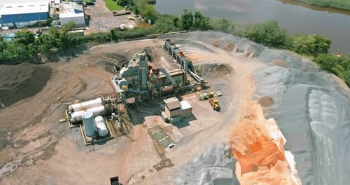 Asphalt Production Factory an Industrial Production Plant Surrounded By Piles of Gravel