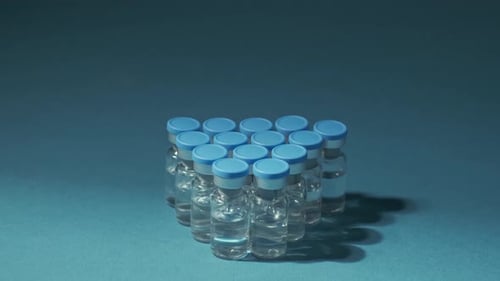 Vaccine Vials in Blue Background Close Up
