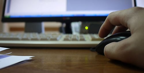 Hand Using Computer Mouse at Desk