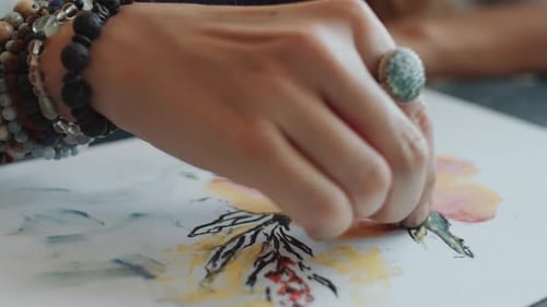 Close Up of Woman Drawing Flowers with Wax Crayon