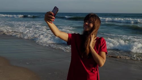 Attractive woman taking a selfie at the beach