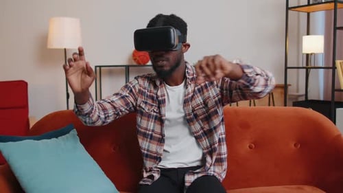 Man on Couch Wearing VR Headset Interacting