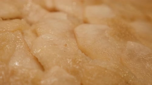 Slow tilt over apple pie caramelized topping texture 4K 2160p 30fps UltraHD footage - Surface of