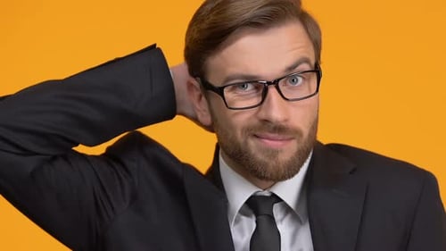 Confused Man Scratching Head in Business Suit