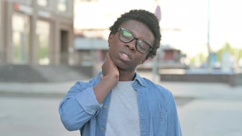 Man With Sore Neck Outdoors Rubbing It