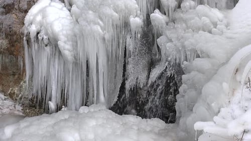 Ice Icicles on Rocky Wall