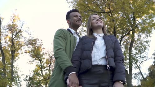 African American and Caucasian Girl Holding Hands in Park