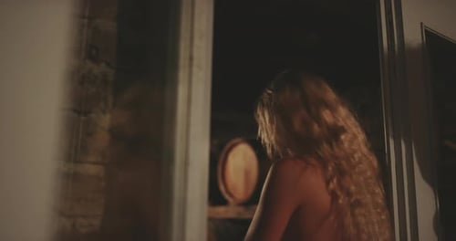 Woman with Blond Hair by Doorway at Night