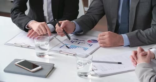 Business Meeting with Data Analysis in Modern Office