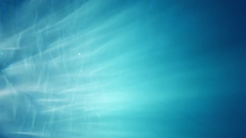 Vertical format screen display - Loop sunlight beams shining through the deep crystal clear turquois