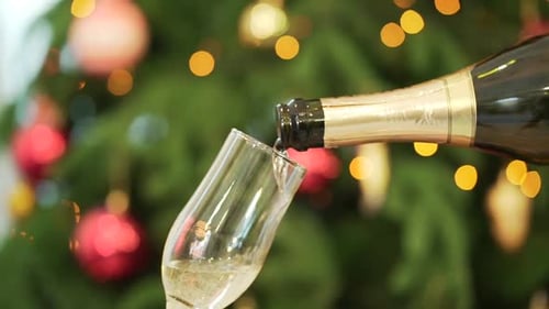 Champagne Poured Near a Christmas Tree