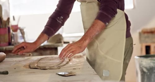 Male potter working on clay in pottery workshop