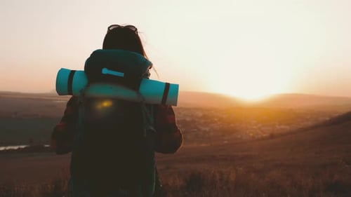 Woman Hiking with Backpack at Sunrise