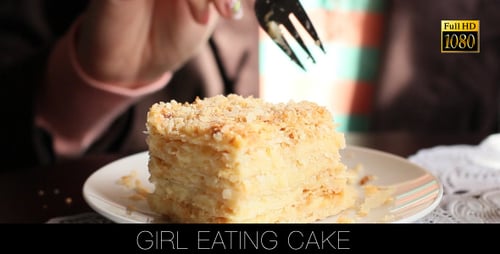 Woman Eating Delicious Piece of Layered Cake