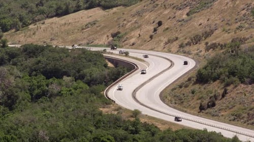 Hot summer day as traffic drives on winding road