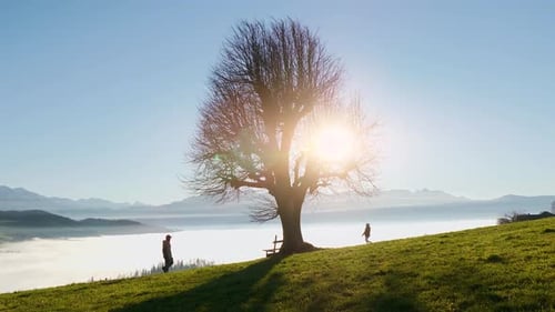 Two Young People Hiking Together in Panoramic Mountain Landscape Standing on Top of Viewpoint