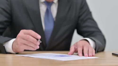 Close Up of Businessman Working on Documents