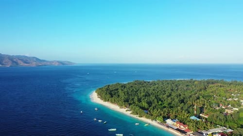 Beautiful birds eye tourism shot of a sunshine white sandy paradise beach and blue water background