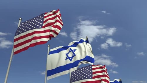 American and Israeli Flags Waving in Wind Against Blue Sky
