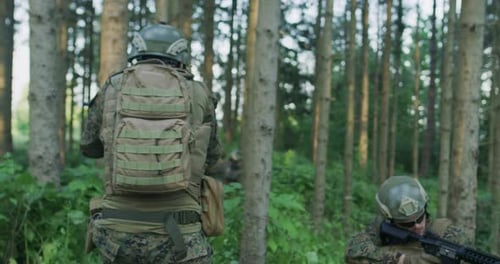 Soldiers in the Smoke Moving in Battle Operation Thorugh Dense Forest
