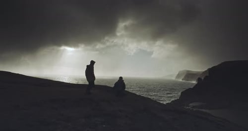 Two people walk together on hilltop