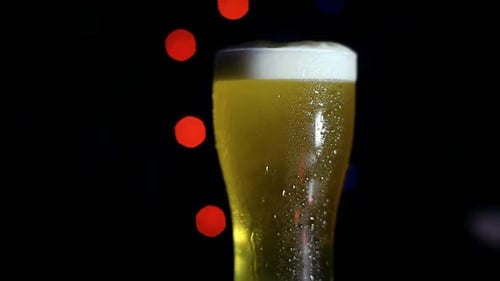 Refreshing Beer with Festive Colorful Bokeh Lights