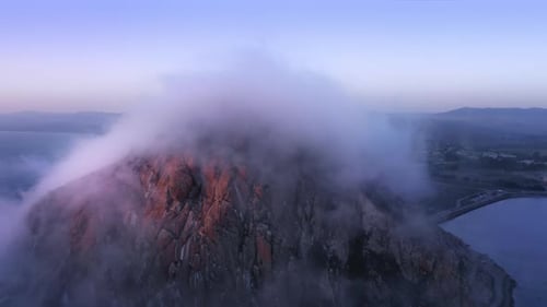 Magic Golden Hour Over Pacific Ocean Coast with Purple and Blue Clouds and Fog