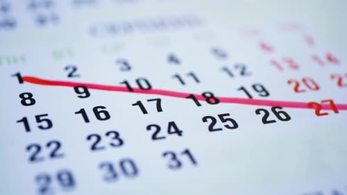 Red Pen Crossing Off Dates on Calendar