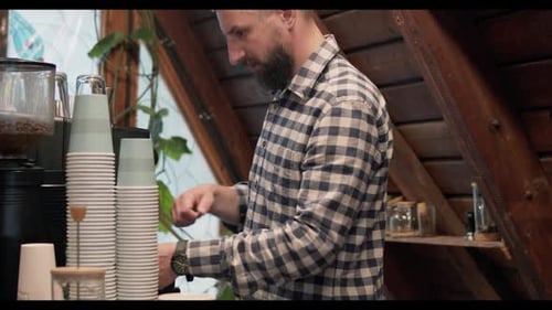 Barista Man Prepares Espresso Behind Cafe Counter
