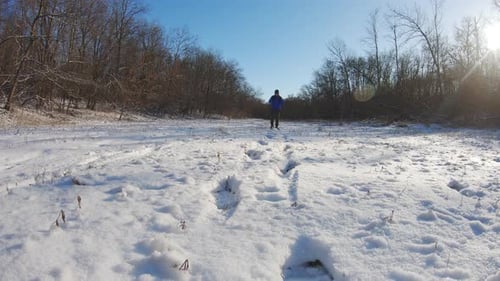 Man Hiking in White Winter Forest with Backpack. Recreation and Healthy Lifestyle Outdoors in Snowy