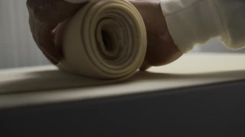 Hands Rolling Dough for Baking Preparation Close Up