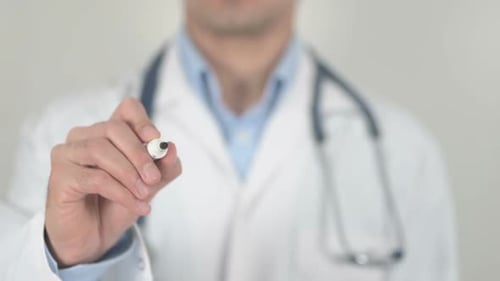 Doctor Writes the Word Zoonotic on Clear Surface