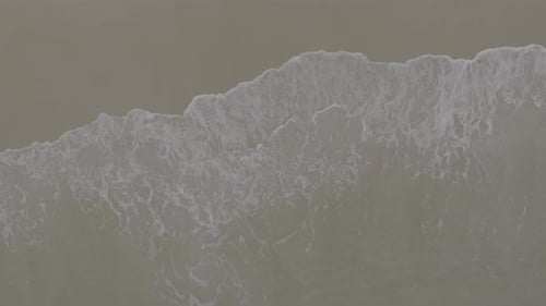 Foamy Waves on Sandy Beach Aerial View