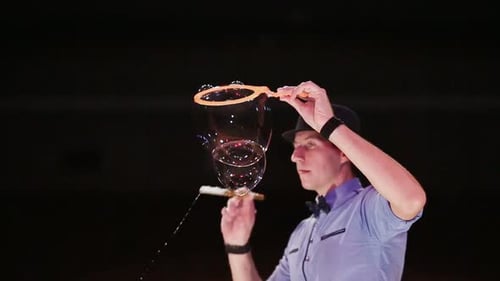 Man Blows Large and Small Bubbles