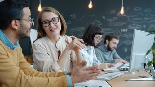 Woman and Man Talking Working in Creative Open Space Office Discussing Business