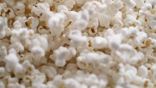 Camera follows popcorn jumping. Slow Motion.