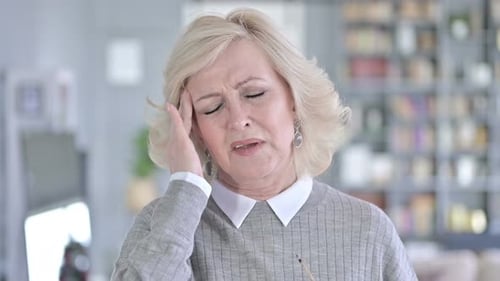 Mature Woman Massaging Temples and Rubbing Forehead